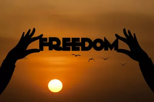 "freedom" written by shadows in a sky over a wonderful sunset